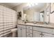 Charming bathroom with a decorative mirror, granite countertops, and white cabinets at 1915 Colony Line Ct, Charlotte, NC 28210