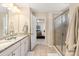 Bathroom with double vanity, glass enclosed shower, and neutral color palette at 1915 Colony Line Ct, Charlotte, NC 28210