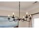 Close-up of a modern chandelier with candle-style lights and a sleek black finish at 1915 Colony Line Ct, Charlotte, NC 28210