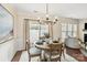 Bright dining room featuring hardwood floors, a modern chandelier, and sliding doors to the backyard at 1915 Colony Line Ct, Charlotte, NC 28210