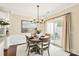 Elegant dining area with a round table, modern chandelier, and sliding glass doors to a patio at 1915 Colony Line Ct, Charlotte, NC 28210