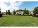 Dog park with a large green lawn enclosed with a black fence, homes visible in the background at 1915 Colony Line Ct, Charlotte, NC 28210