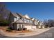 Row of well-maintained townhomes with stone accents, attached garages, and manicured landscaping at 1915 Colony Line Ct, Charlotte, NC 28210