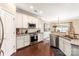 Open-concept kitchen with stainless steel appliances, granite countertops, and a view into the dining area at 1915 Colony Line Ct, Charlotte, NC 28210