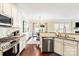 Open kitchen with stainless steel appliances, granite countertops, and a view of the dining area at 1915 Colony Line Ct, Charlotte, NC 28210