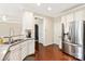 Well-lit kitchen boasts stainless steel refrigerator and features hardwood floors and granite countertops at 1915 Colony Line Ct, Charlotte, NC 28210