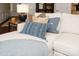 Close-up of a comfortable sofa with decorative pillows and a throw blanket in a well-lit living room at 1915 Colony Line Ct, Charlotte, NC 28210