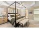 Spacious main bedroom featuring a canopy bed, tray ceiling, and neutral color palette at 1915 Colony Line Ct, Charlotte, NC 28210