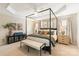 Bedroom with decorative tray ceiling, four-poster bed, and neutral color palette at 1915 Colony Line Ct, Charlotte, NC 28210