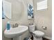 Stylish powder room with pedestal sink, modern fixtures, and a decorative mirror at 1915 Colony Line Ct, Charlotte, NC 28210