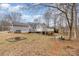 Large backyard featuring a multi-level deck and treed views at 207 Cypress Dr, Gastonia, NC 28052