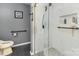 Modern bathroom featuring a glass-enclosed shower with sleek fixtures and a unique tiled floor at 207 Cypress Dr, Gastonia, NC 28052