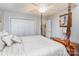 Bedroom showcasing a four-poster bed, ceiling fan, and a double door closet for plenty of storage at 207 Cypress Dr, Gastonia, NC 28052