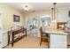 Dining area featuring stylish decor, bar seating, and seamless transition to a sunlit room at 207 Cypress Dr, Gastonia, NC 28052