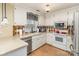 Functional kitchen with white cabinets, tile backsplash, stainless steel appliances, and lots of counter space at 207 Cypress Dr, Gastonia, NC 28052