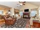 Cozy living room with fireplace, vaulted ceiling, neutral color scheme, and seamless flow to the kitchen at 207 Cypress Dr, Gastonia, NC 28052