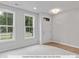 Lower level flex room with light gray walls and lots of natural light from the two large windows at 214 Gilead Rd, Huntersville, NC 28078