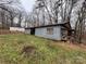 Image of a barn with a metal roof on a property with abundant foliage and greenery at 2211 Unionville Indian Trl, Indian Trail, NC 28079