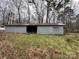 An image of a gray barn with an opening on a lush green property at 2211 Unionville Indian Trl, Indian Trail, NC 28079