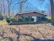 Charming brick home featuring a well-maintained front yard with mature trees and landscaping at 2211 Unionville Indian Trl, Indian Trail, NC 28079