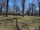 Single story home set back off road, surrounded by mature trees and wooded landscaping at 2211 Unionville Indian Trl, Indian Trail, NC 28079