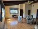 Living room with hardwood floors, high ceilings with exposed beams, and natural light at 2211 Unionville Indian Trl, Indian Trail, NC 28079