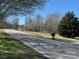 Street view of the road near the property, showcasing the surrounding landscape at 2211 Unionville Indian Trl, Indian Trail, NC 28079