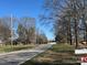 Street view showing the road frontage, tree lined street, and neighborhood at 2211 Unionville Indian Trl, Indian Trail, NC 28079