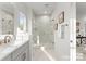Bright bathroom showcasing a glass-enclosed shower, modern sink and cabinets and neutral colors at 2223 Edison St, Charlotte, NC 28206