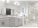Luxurious bathroom featuring a double vanity, sleek modern fixtures, and glass enclosed shower at 2223 Edison St, Charlotte, NC 28206