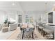 Bright and airy dining area open to the kitchen, featuring sleek modern decor and hardwood floors at 2223 Edison St, Charlotte, NC 28206