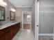 Bathroom boasts double sinks with granite countertops and tiled floors plus a closet at 2227 Cashmere Ct, Denver, NC 28037