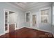 Cozy bedroom with hardwood floors, tray ceiling, and natural light from windows at 2227 Cashmere Ct, Denver, NC 28037