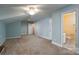 A bedroom with adjoining bathroom with ceiling fan and neutral carpet at 2227 Cashmere Ct, Denver, NC 28037