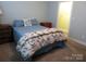 Neutral tones and a floral quilt adorn this bedroom, with a walk-in closet off to the side at 2227 Cashmere Ct, Denver, NC 28037