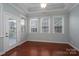 Bedroom features hardwood floors, tray ceiling, and natural light from large windows at 2227 Cashmere Ct, Denver, NC 28037
