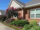 Brick home with mature landscaping, colorful trees, and lush green bushes at 2227 Cashmere Ct, Denver, NC 28037