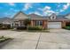 Brick home with a two-car garage and lovely landscaping at 2227 Cashmere Ct, Denver, NC 28037