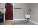 Garage area with a utility sink, tool chest, and coat rack by the door at 2227 Cashmere Ct, Denver, NC 28037