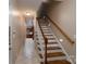 Hallway and staircase with wood and white trim leading to kitchen at 2227 Cashmere Ct, Denver, NC 28037