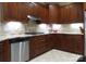 Well-equipped kitchen featuring stone backsplash, wood cabinets, and modern appliances at 2227 Cashmere Ct, Denver, NC 28037