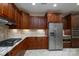 A kitchen featuring wooden cabinets, stone countertops, and stainless steel appliances at 2227 Cashmere Ct, Denver, NC 28037