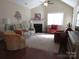 Cozy living room featuring hardwood floors, neutral walls, and a fireplace at 2227 Cashmere Ct, Denver, NC 28037