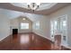 Open living room with fireplace, hardwood floors, and light-filled windows at 2227 Cashmere Ct, Denver, NC 28037