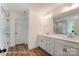 Elegant bathroom featuring a double sink vanity, wood flooring, and a glass-enclosed shower at 2228 Tabor Rd # 569, Sherrills Ford, NC 28673