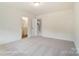 Bright and airy bedroom showcasing neutral carpeting and an ensuite bathroom and staircase at 2228 Tabor Rd # 569, Sherrills Ford, NC 28673