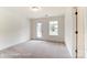 Cozy bedroom with neutral carpeting, a door to a balcony, and a bright window at 2228 Tabor Rd # 569, Sherrills Ford, NC 28673