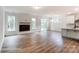 Open-concept living room featuring a modern fireplace, wood flooring, and a seamless transition to the kitchen area at 2228 Tabor Rd # 569, Sherrills Ford, NC 28673