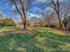 Sprawling backyard featuring lush green lawn and soccer net, perfect for outdoor activities at 2326 Lathrop Ln, Charlotte, NC 28211