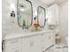 This bathroom is complete with marble countertops, sinks and two beveled mirrors at 2326 Lathrop Ln, Charlotte, NC 28211